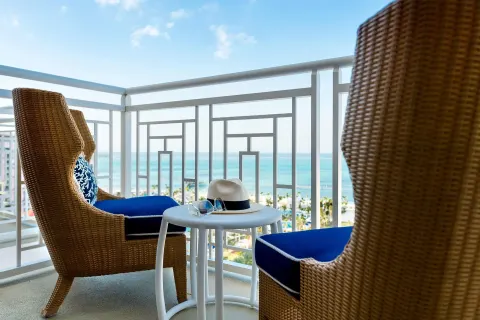 Ocean view balcony with wicker chairs at Grand Hyatt Baha Mar.