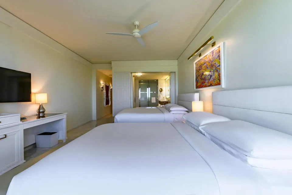 Two queen beds and open bath area in a guest room at Grand Hyatt Baha Mar.