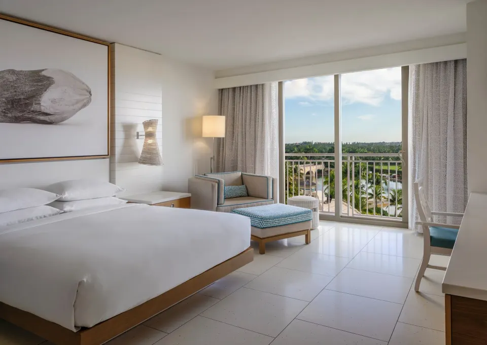 King bed room with balcony doors and fountain view at Grand Hyatt Baha Mar.