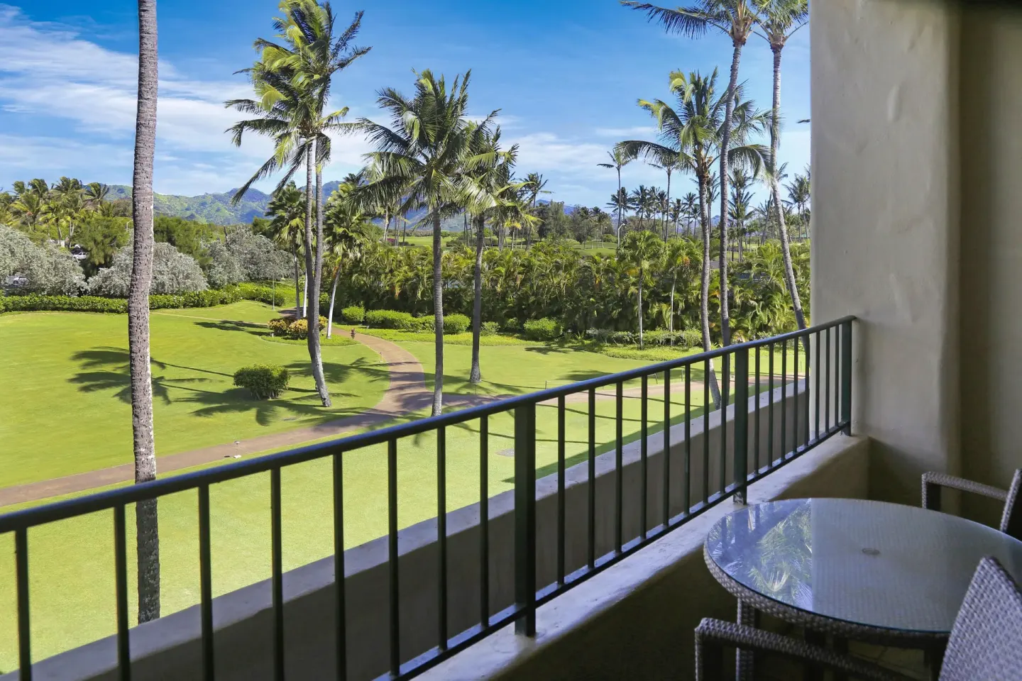 Guest room balcony overlooking lawns and palms at Grand Hyatt Kauai Resort and Spa and Spa.
