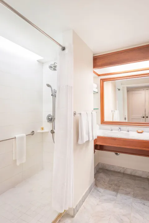 Bathroom with walk-in shower and vanity at Grand Hyatt Kauai Resort and Spa and Spa.