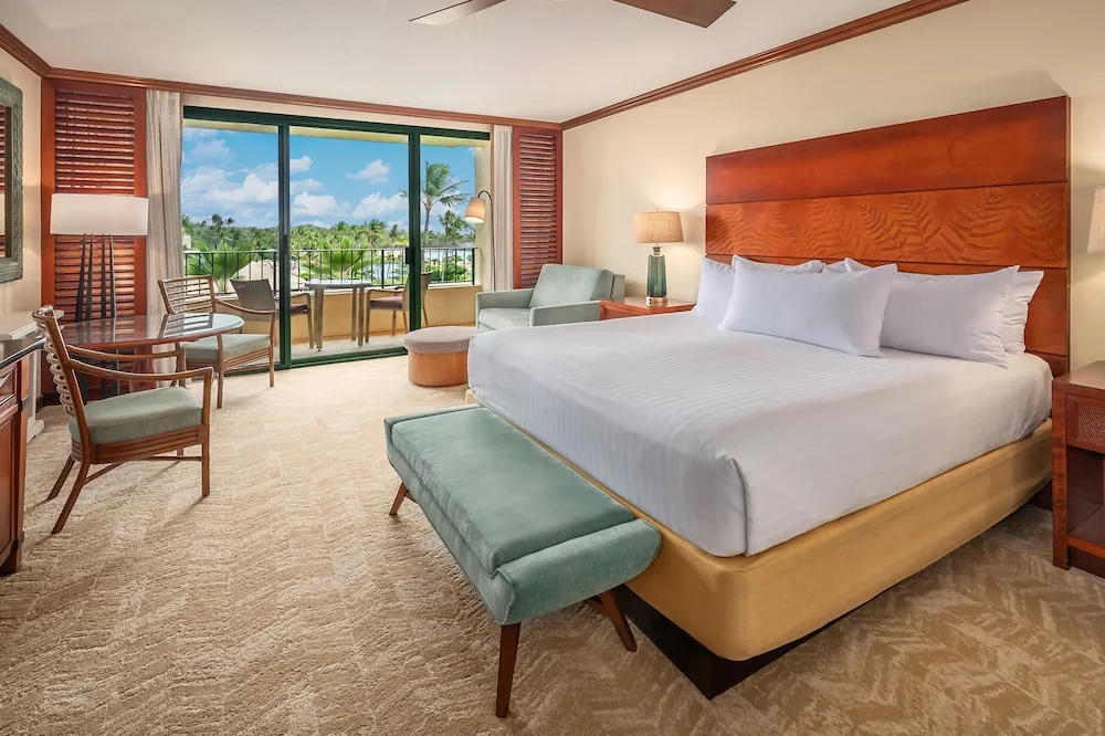 King bed guest room with balcony and garden view at Grand Hyatt Kauai Resort and Spa and Spa.