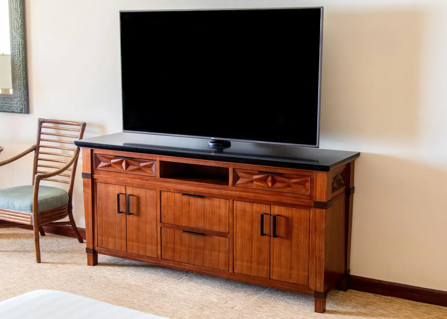 Guest room television on a carved wood cabinet at Grand Hyatt Kauai Resort and Spa and Spa.