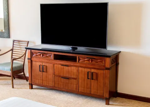Guest room television on a carved wood cabinet at Grand Hyatt Kauai Resort and Spa and Spa.