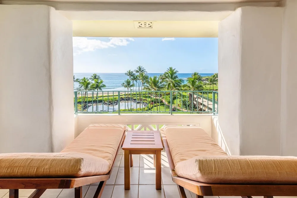Balcony with two chaise lounges and ocean view at Grand Hyatt Kauai Resort and Spa and Spa.