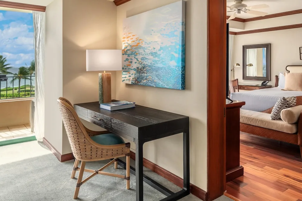 Suite desk area beside an ocean-view balcony at Grand Hyatt Kauai Resort and Spa and Spa.