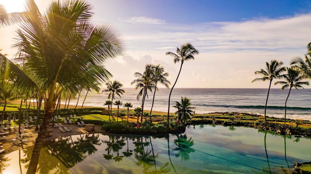 Oceanfront pool with palm reflections at Grand Hyatt Kauai Resort and Spa and Spa.
