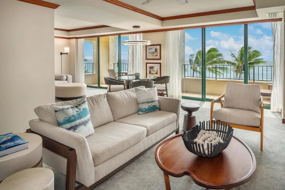 Suite living and dining area with oceanfront balcony at Grand Hyatt Kauai Resort and Spa and Spa.