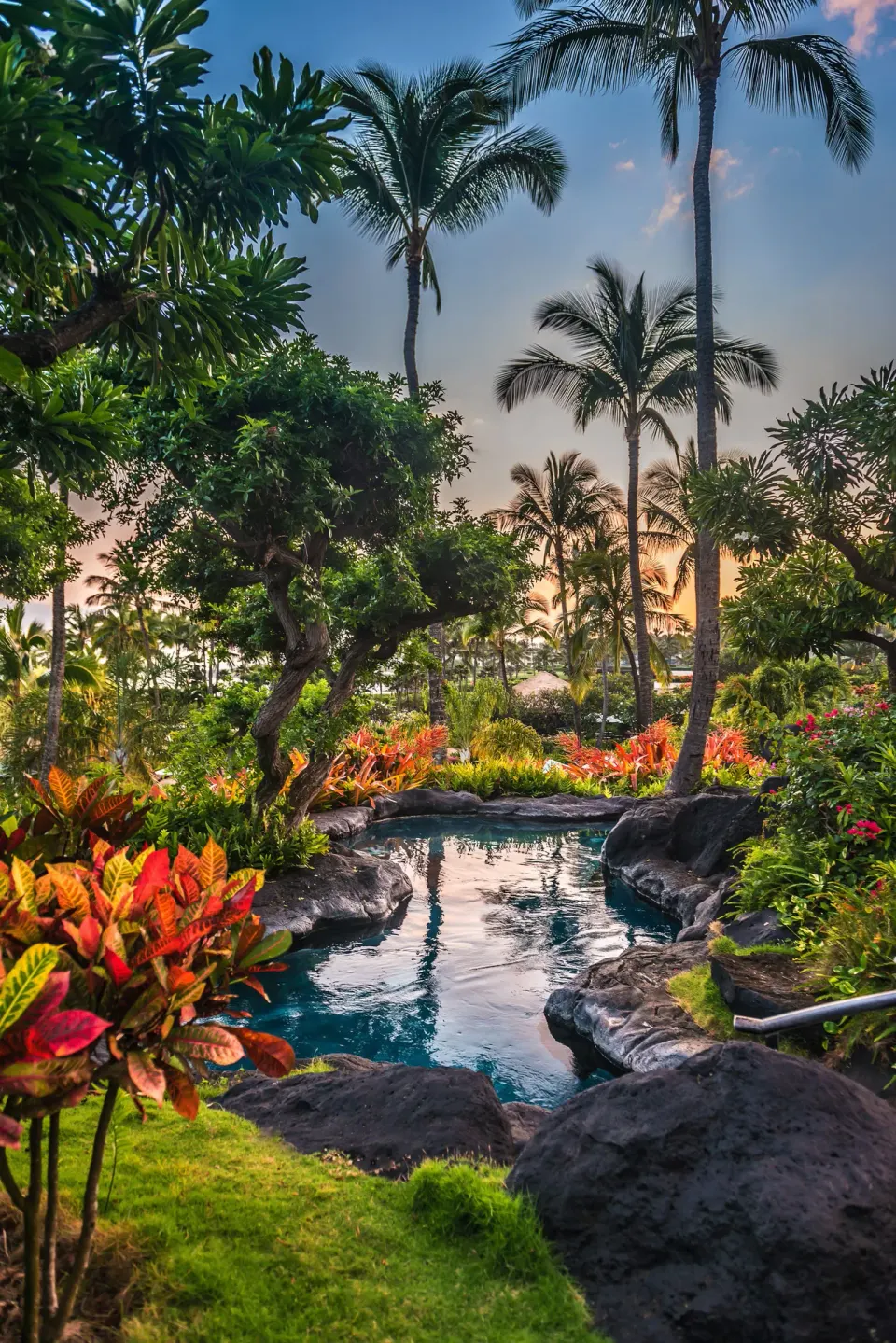 Tropical garden stream with palms at Grand Hyatt Kauai Resort and Spa and Spa.