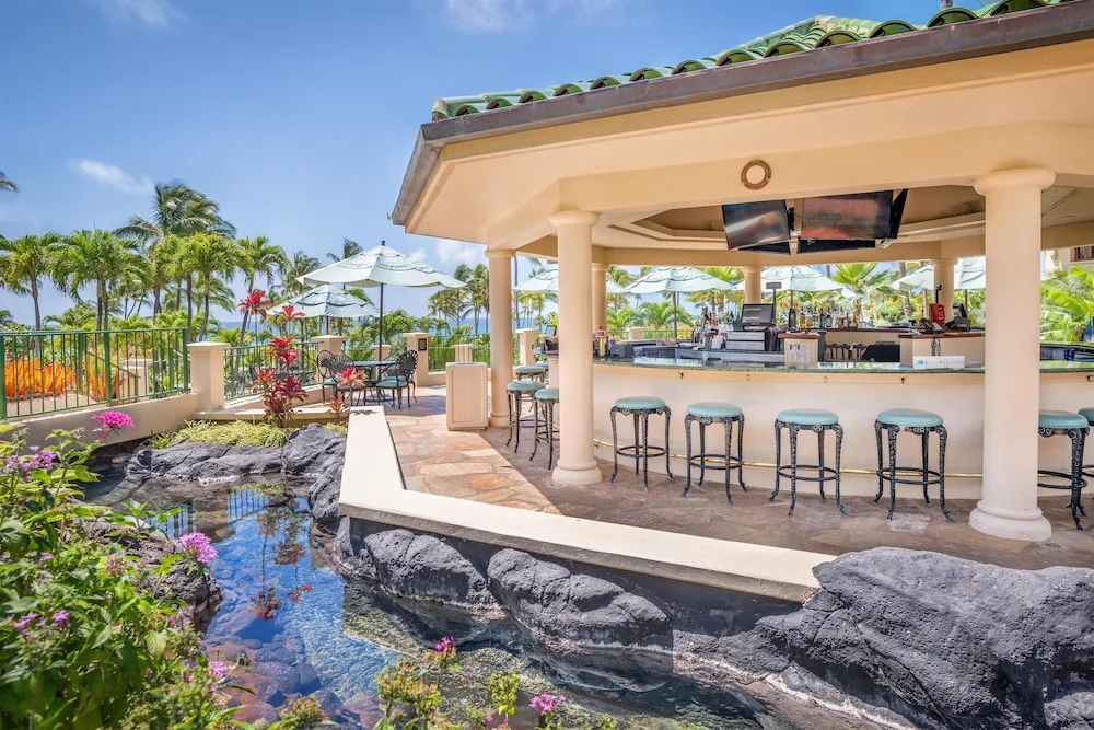 Open-air poolside bar with stools at Grand Hyatt Kauai Resort and Spa and Spa.