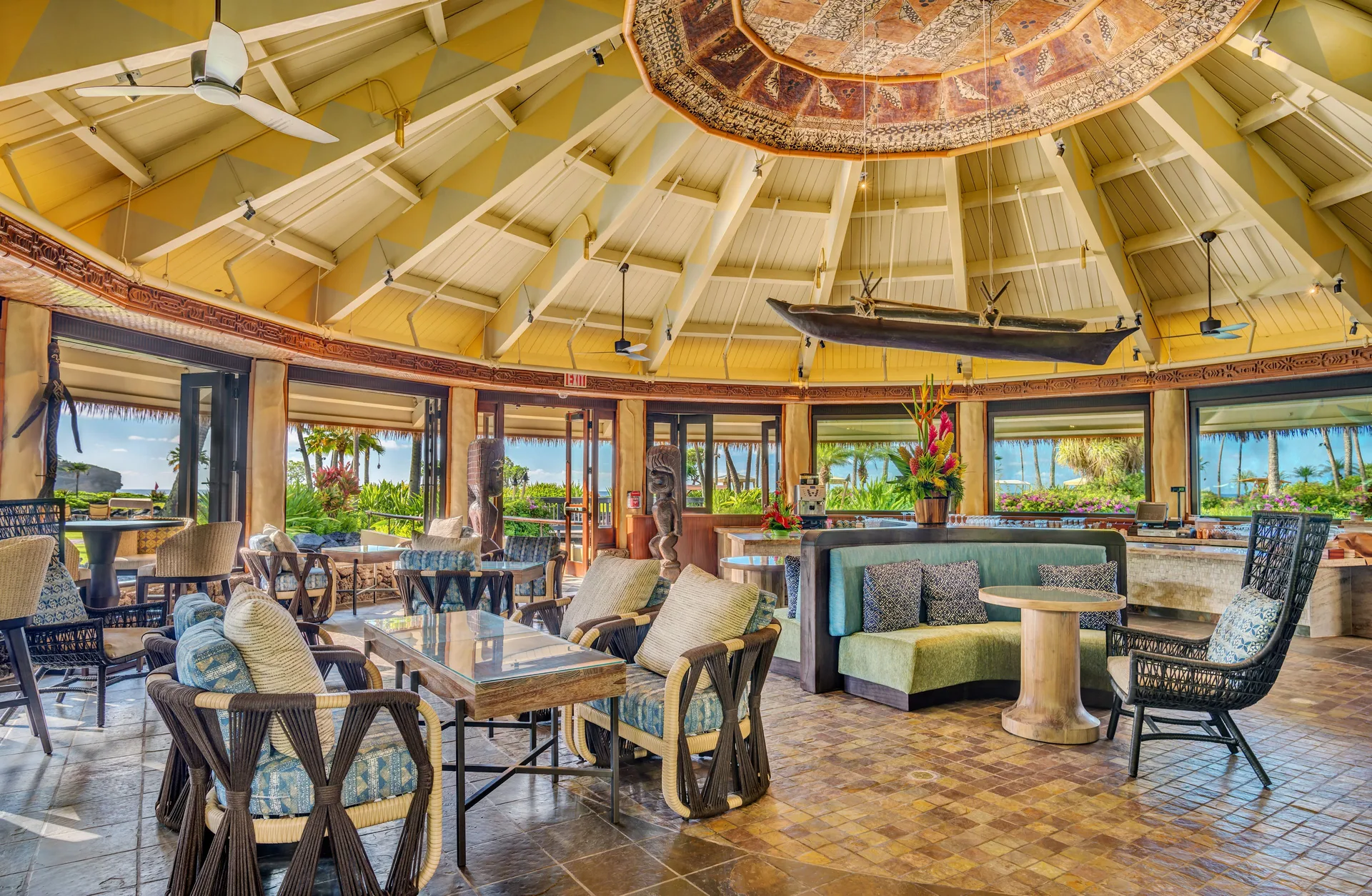 Open lounge with canoe decor and ocean glimpses at Grand Hyatt Kauai Resort and Spa and Spa.