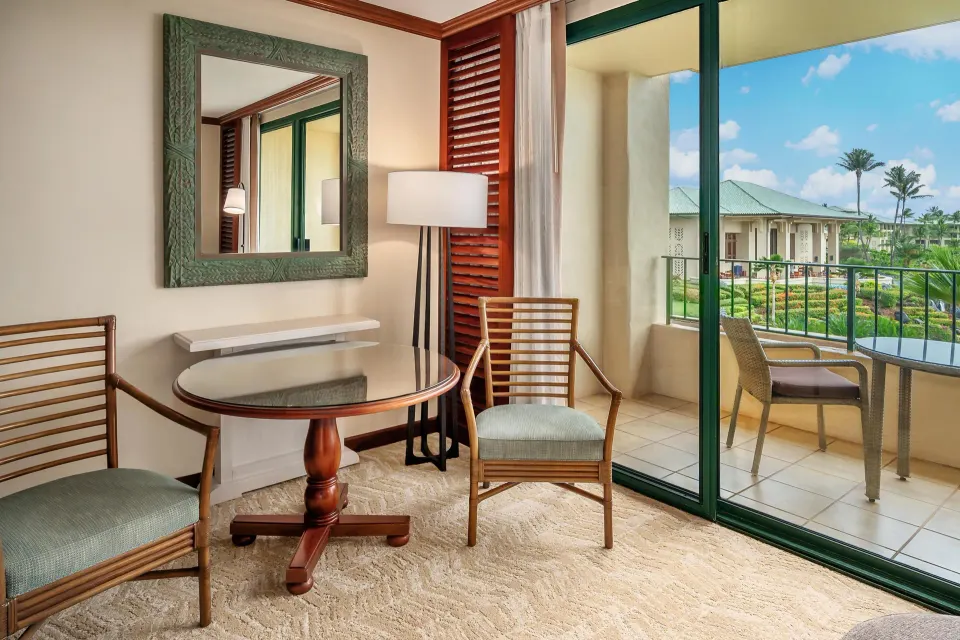 Sitting area and balcony view in a Grand Hyatt Kauai Resort and Spa and Spa Resort View room.