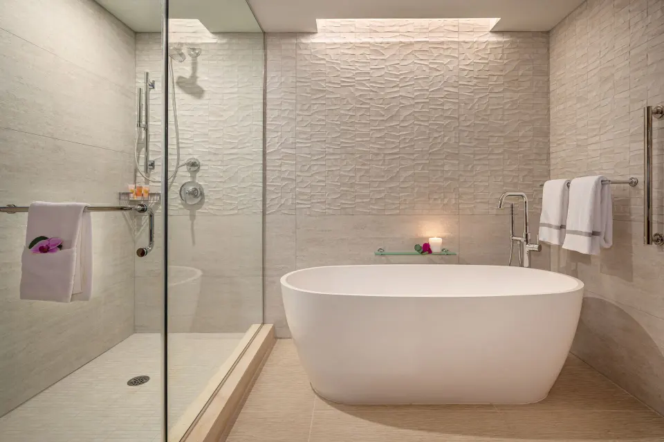Royal Suite bathroom with freestanding tub and glass shower at Grand Hyatt Kauai Resort and Spa and Spa.