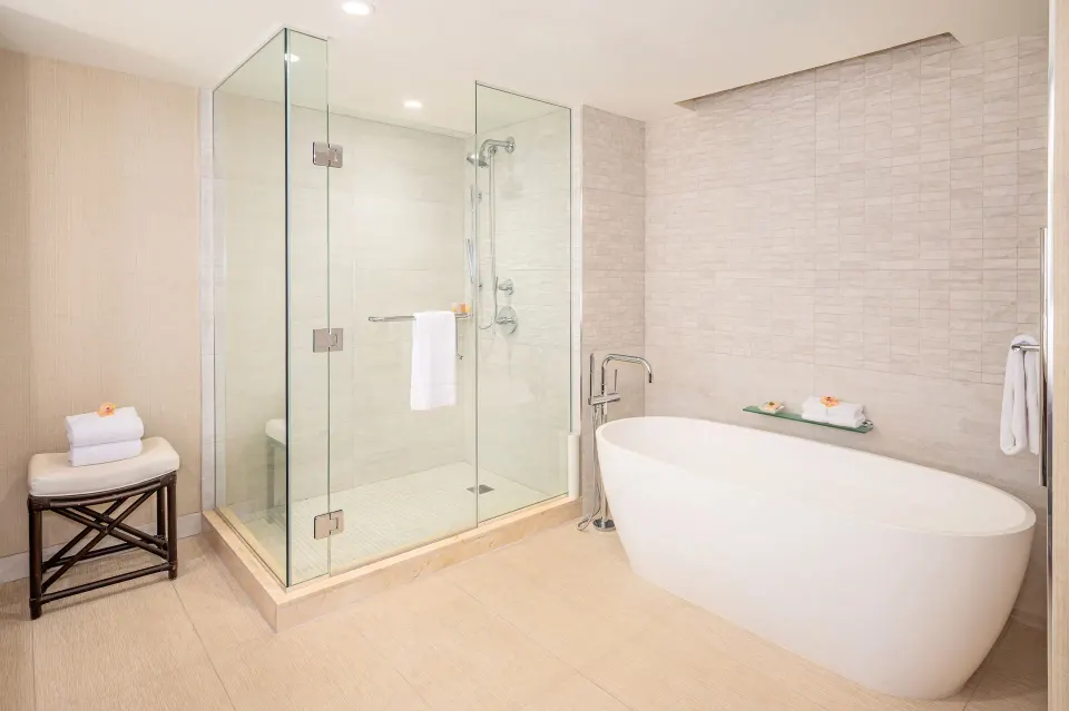 Ocean view suite bathroom with glass shower and soaking tub at Grand Hyatt Kauai Resort and Spa and Spa.