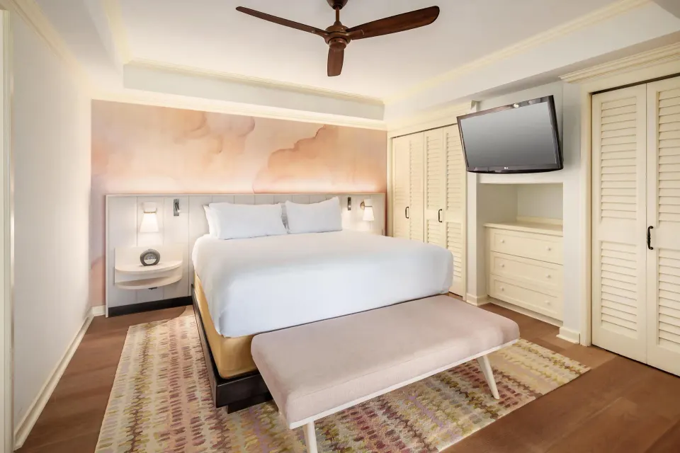 Ocean view suite bedroom with king bed and wall-mounted TV at Grand Hyatt Kauai Resort and Spa and Spa.