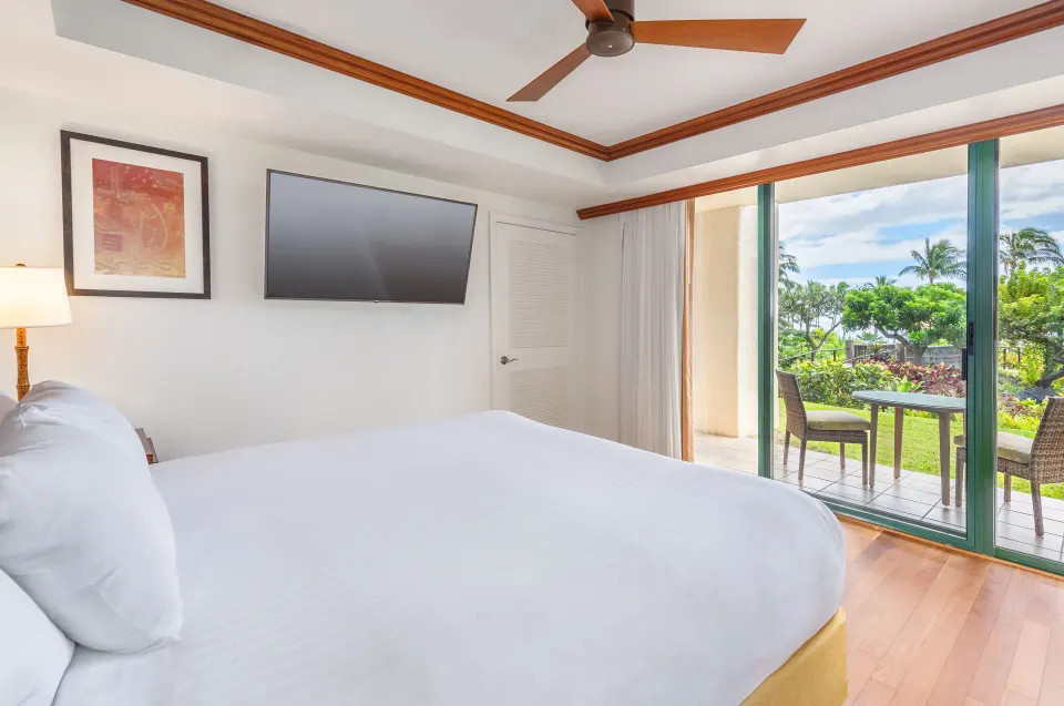 Pool Suite bedroom with king bed and garden patio at Grand Hyatt Kauai Resort and Spa and Spa.