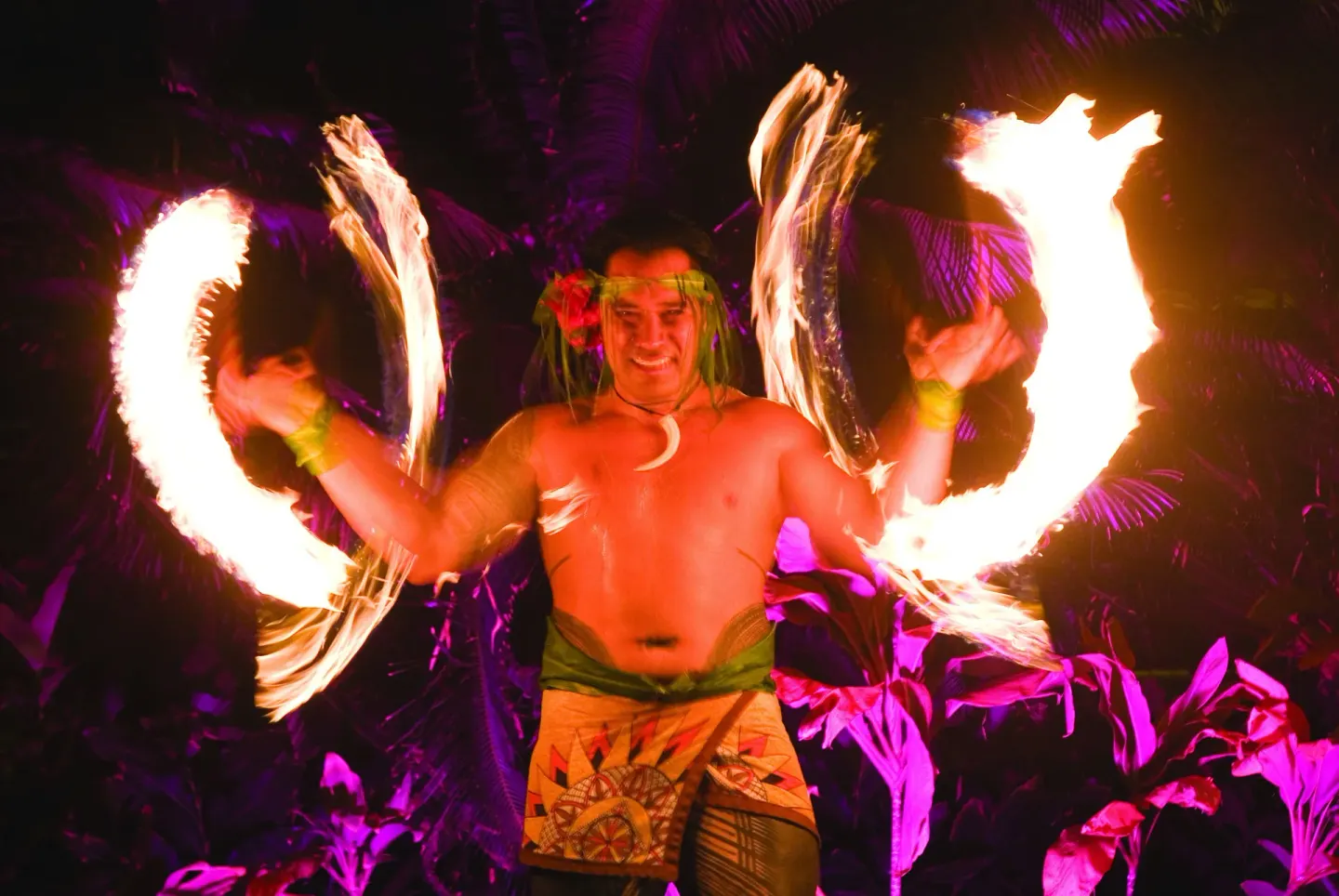 Fire dancer performing at night at Grand Hyatt Kauai Resort and Spa and Spa.
