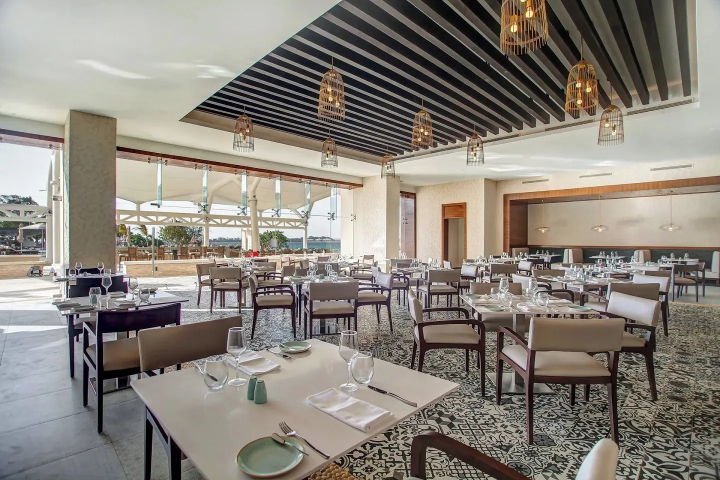 Open-air restaurant dining room with ocean beyond at Grand Lido Negril Au-Naturel.