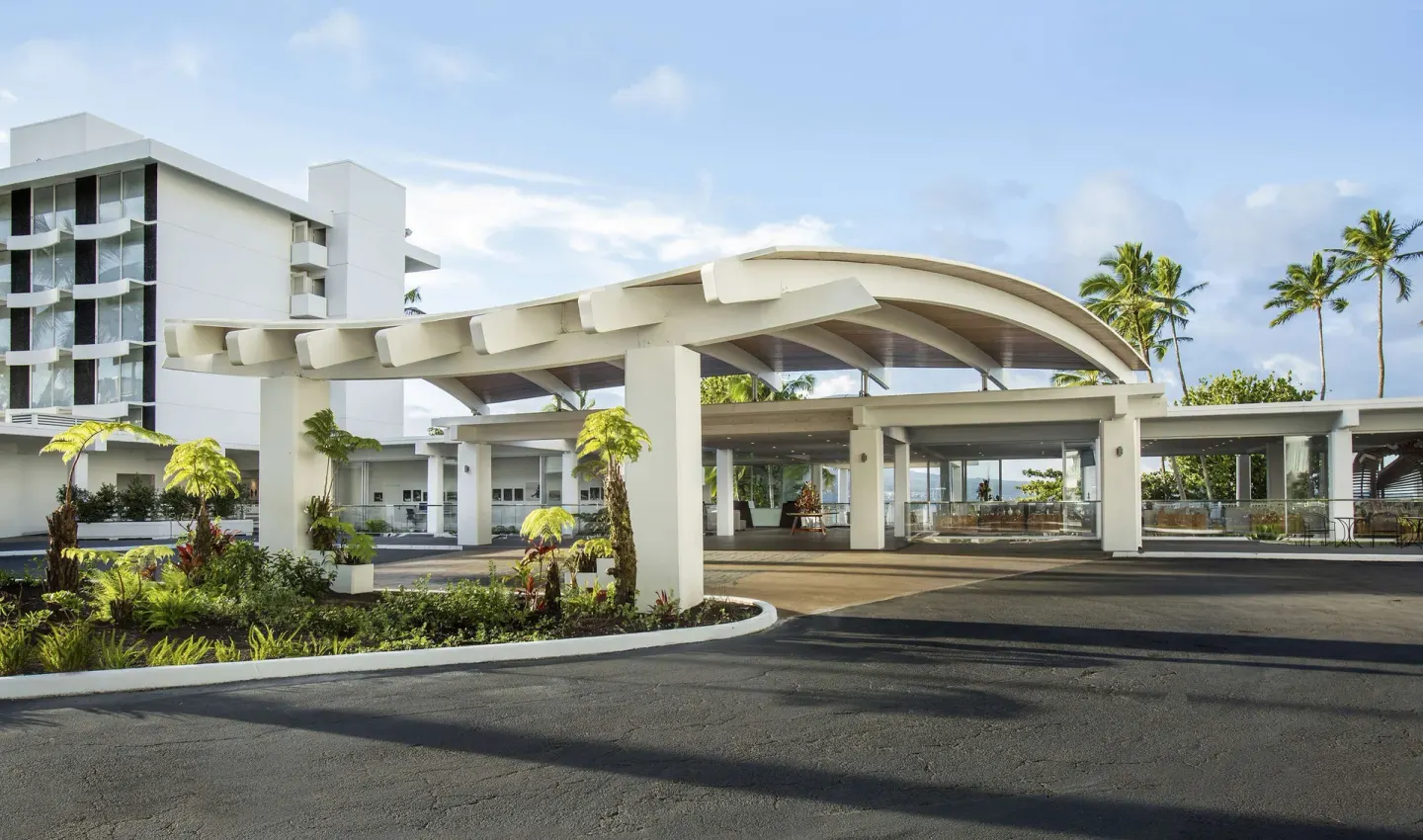 Covered entrance driveway and tropical landscaping at Grand Naniloa Hotel Hilo.