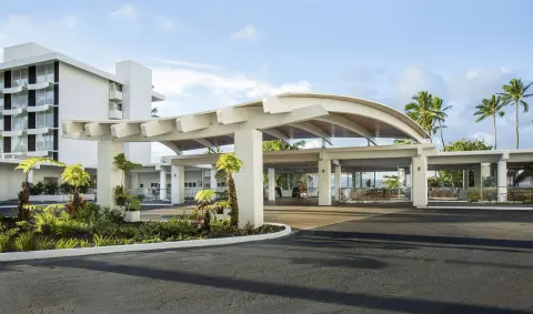Covered entrance driveway and tropical landscaping at Grand Naniloa Hotel Hilo.