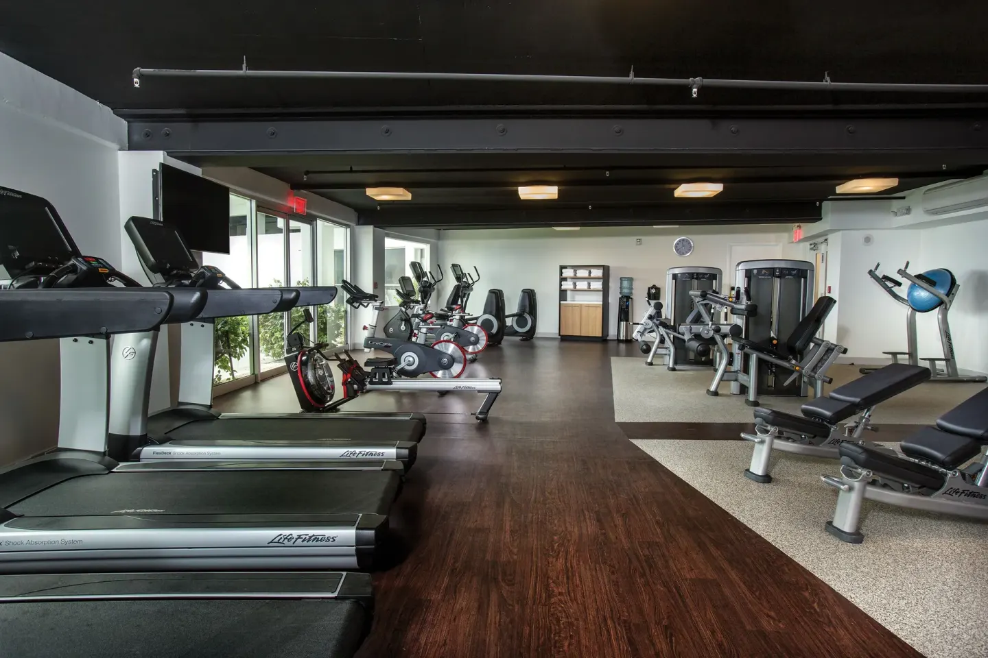 Fitness center with treadmills, bikes, and weight machines at Grand Naniloa Hotel Hilo.