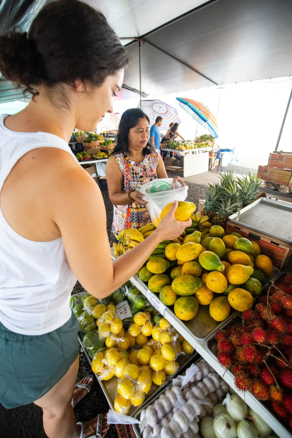 Guest buys tropical fruit at a market near Grand Naniloa Hotel Hilo.