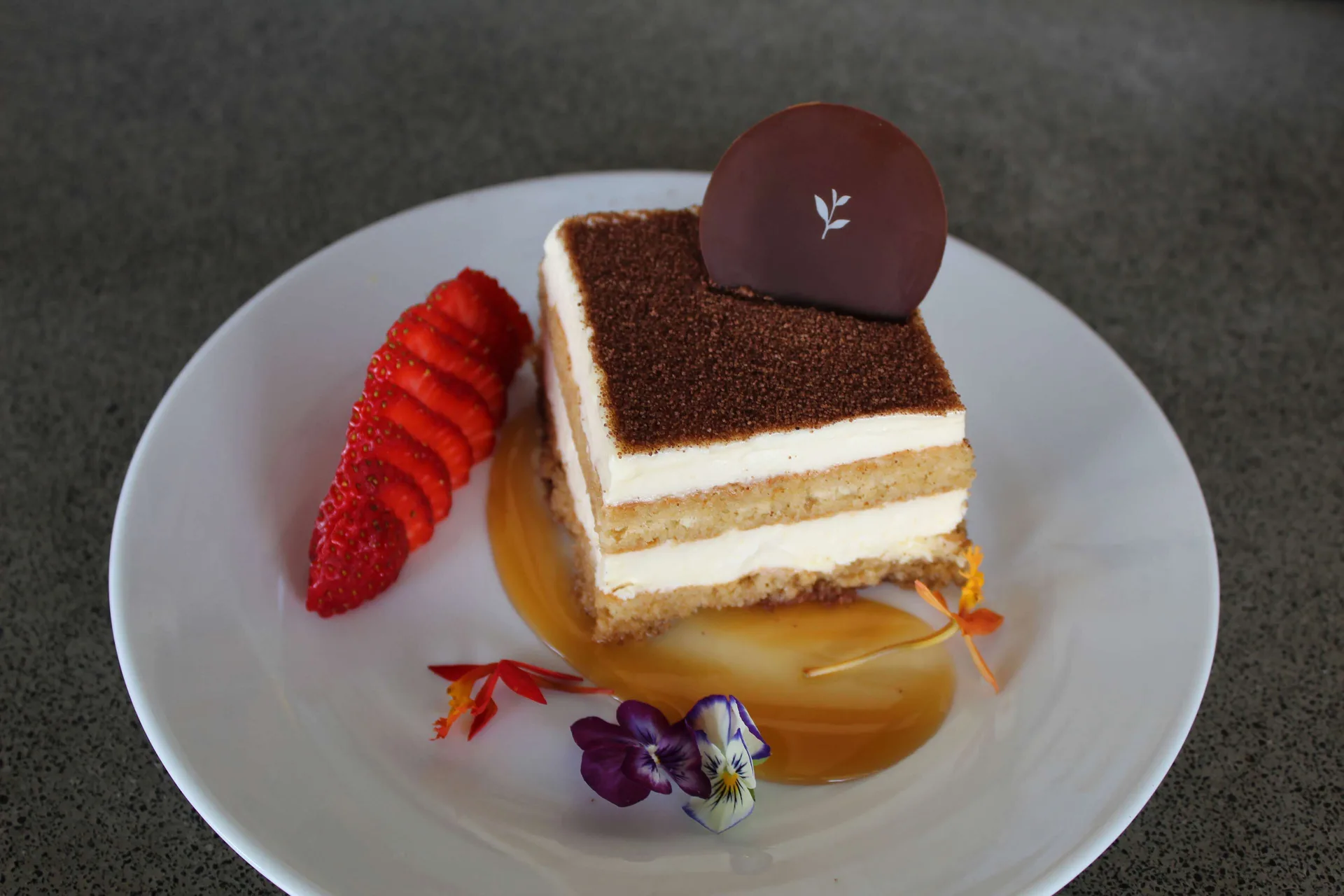 Layered dessert with strawberries and edible flowers at Grand Naniloa Hotel Hilo.