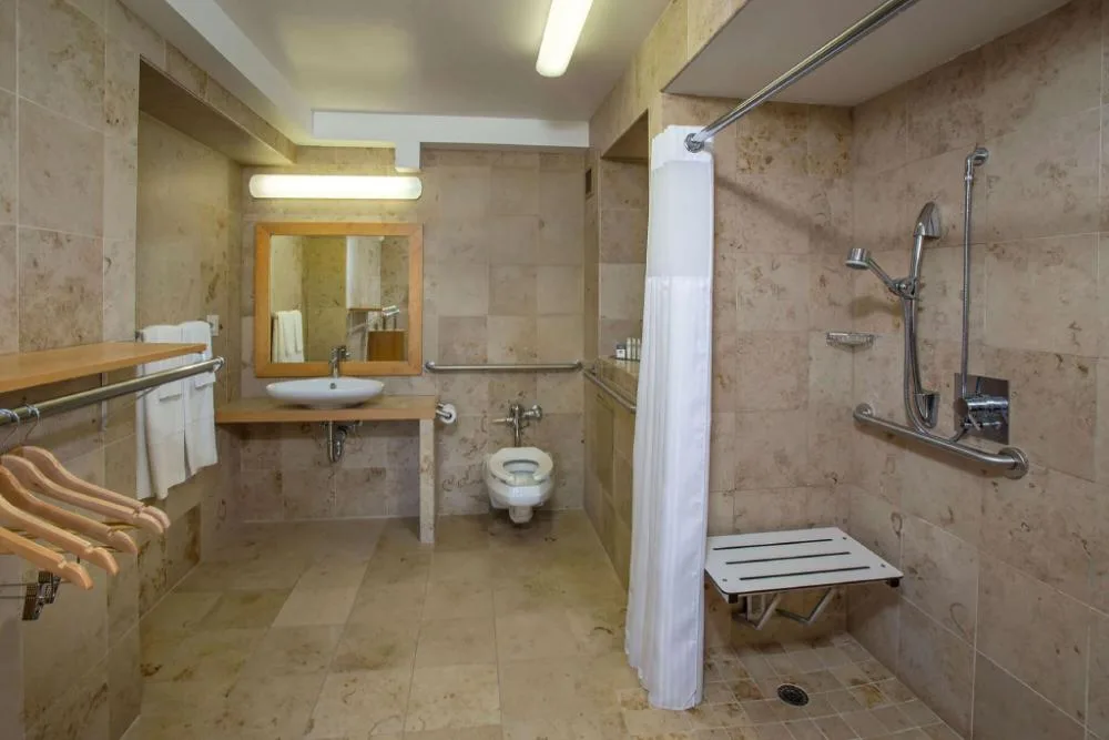 Accessible bathroom with roll-in shower in a king room at Grand Naniloa Hotel Hilo.