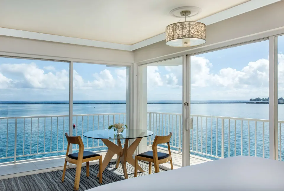 Oceanfront junior suite dining table and balcony views at Grand Naniloa Hotel Hilo.