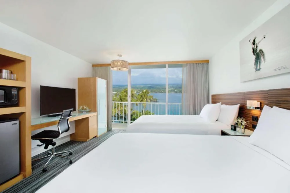 Oceanfront two-bed room with lanai doors at Grand Naniloa Hotel Hilo.