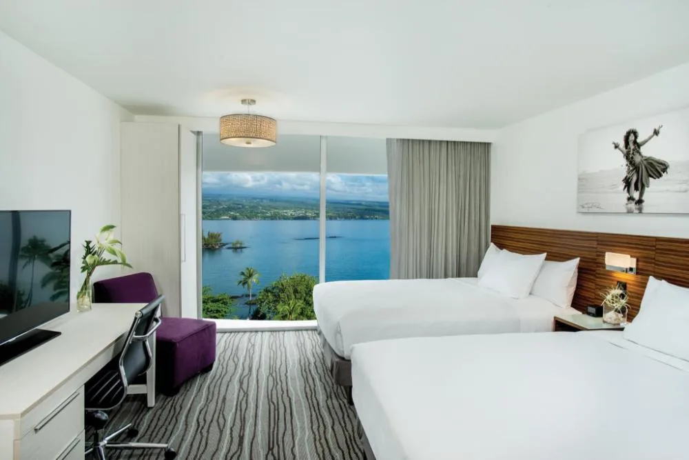 Oceanfront room with two beds and a broad bay view at Grand Naniloa Hotel Hilo.