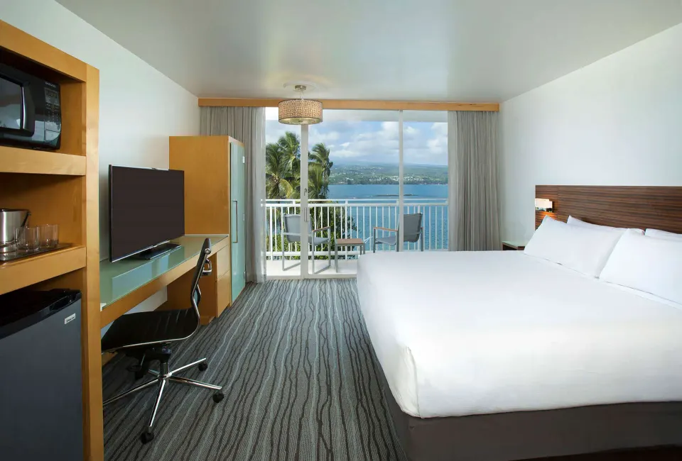 Oceanfront king guest room with lanai and bay view at Grand Naniloa Hotel Hilo.