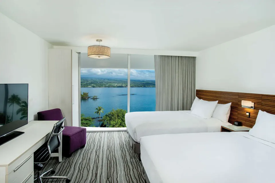 Two-bed ocean view room with picture window at Grand Naniloa Hotel Hilo.