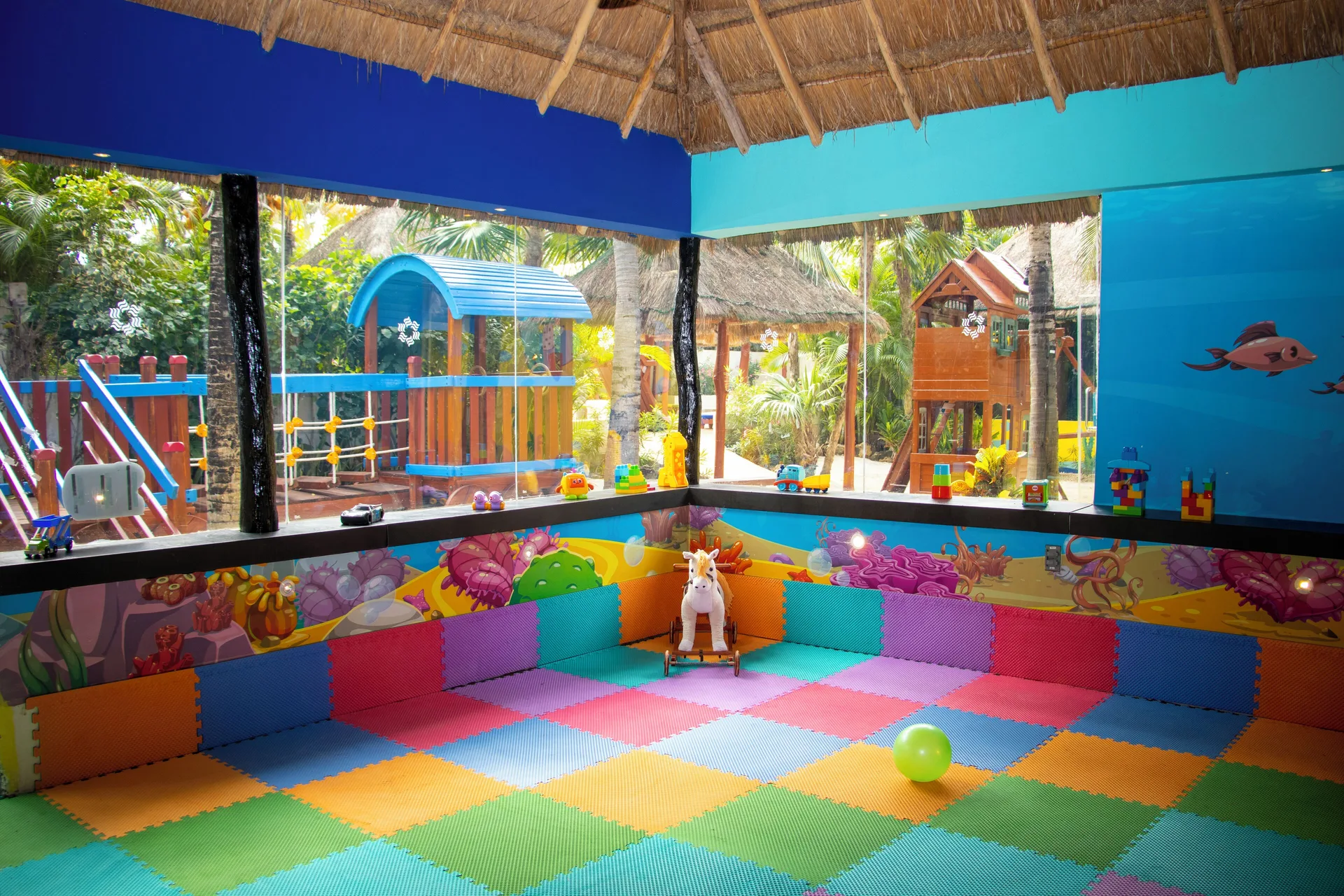 Colorful kids playroom with foam mats and toys at Grand Oasis Cancun.
