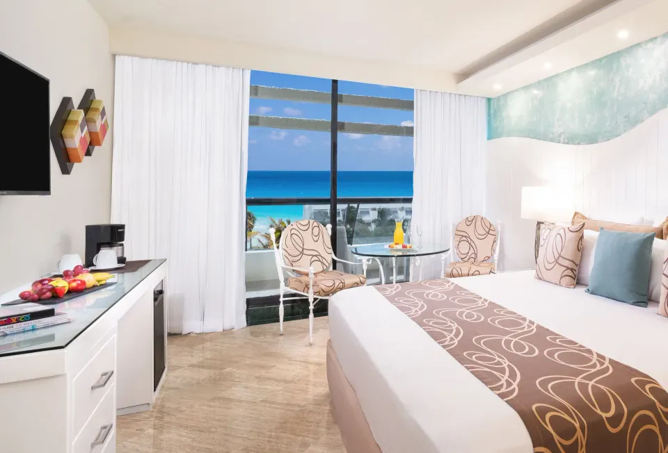 Grand Ocean View room with king bed and balcony ocean view at Grand Oasis Cancun.