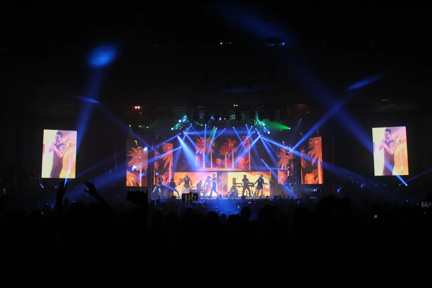 Live stage show with colorful lights and large screens at Grand Oasis Cancun.