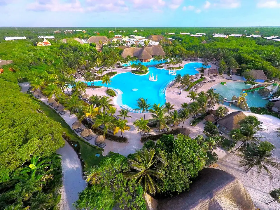 Aerial view of the resort pool complex surrounded by palms at Grand Palladium Colonial Resort & Spa