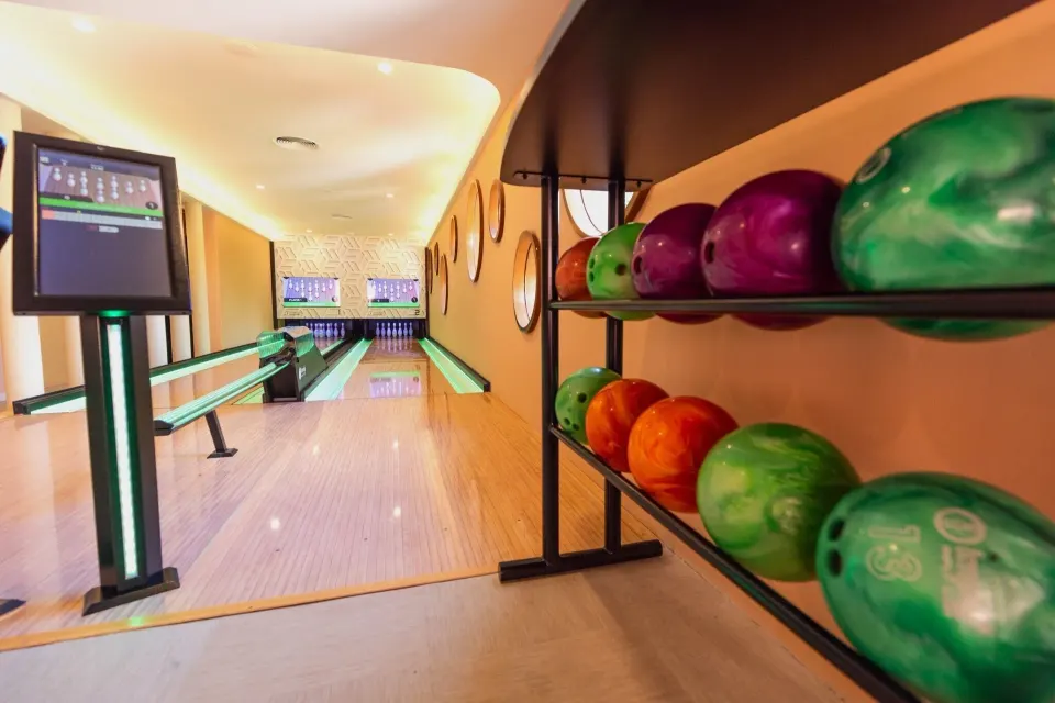 Indoor bowling lanes and colorful balls at Grand Palladium Colonial Resort & Spa