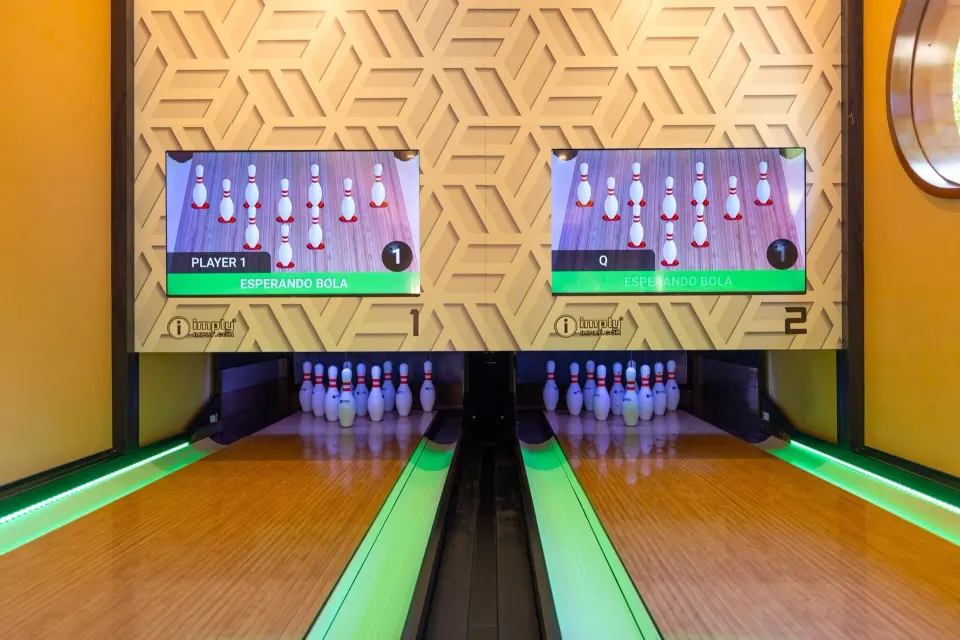 Close-up of bowling pins and digital score screens at Grand Palladium Colonial Resort & Spa