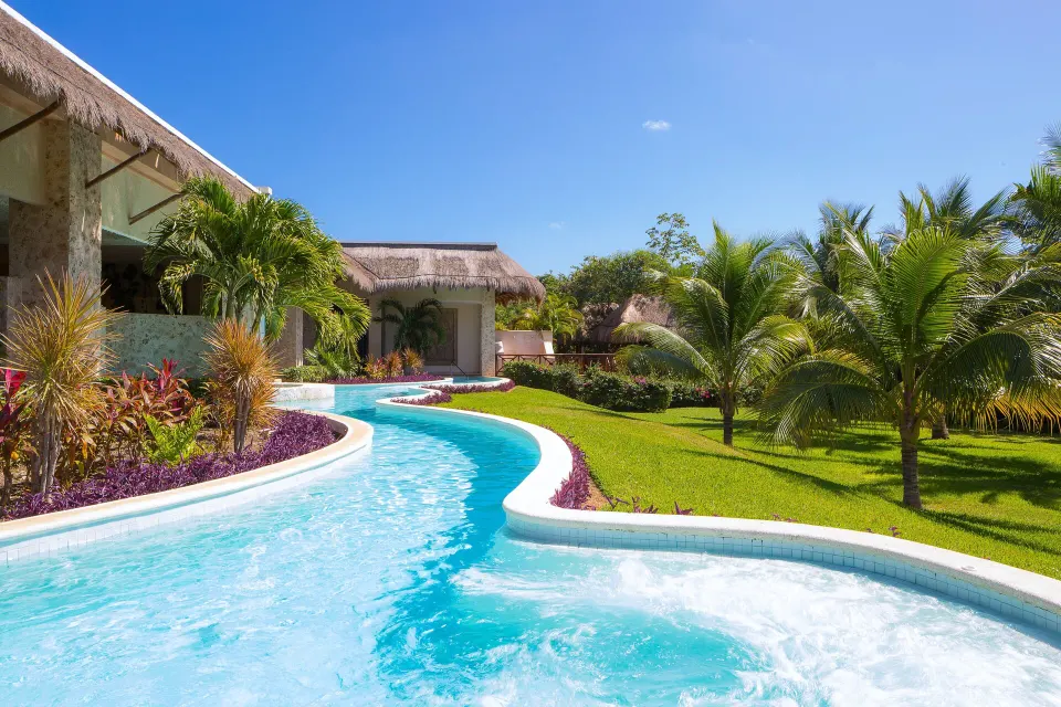 Curving lazy river and garden landscaping at Grand Palladium Colonial Resort & Spa