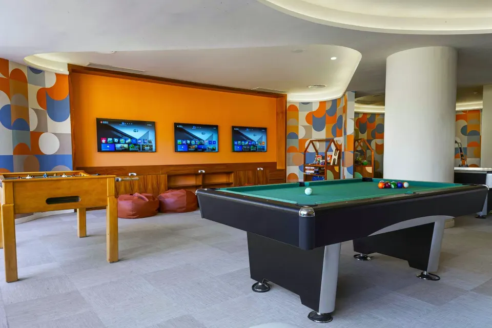 Games room with pool table, foosball and TV screens at Grand Palladium Colonial Resort & Spa