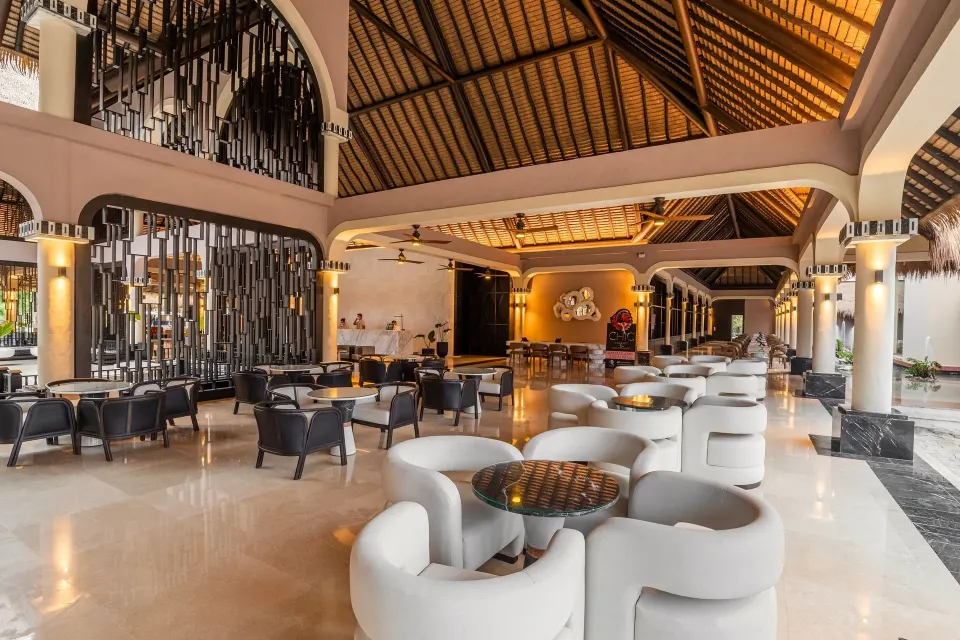 Wide lobby view with curved sofas at Grand Palladium Colonial Resort & Spa