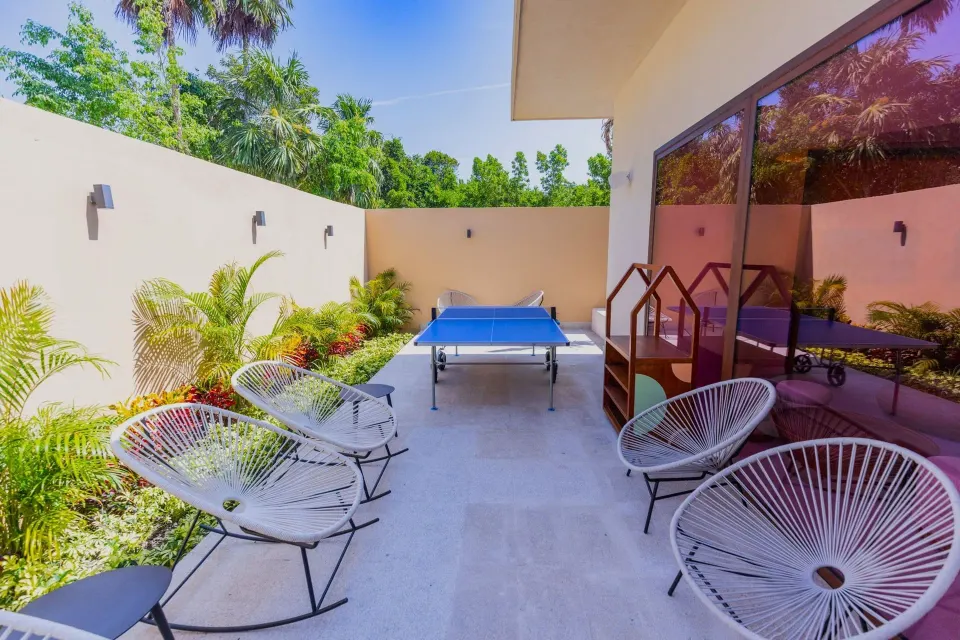 Outdoor patio with ping-pong table and seating at Grand Palladium Colonial Resort & Spa