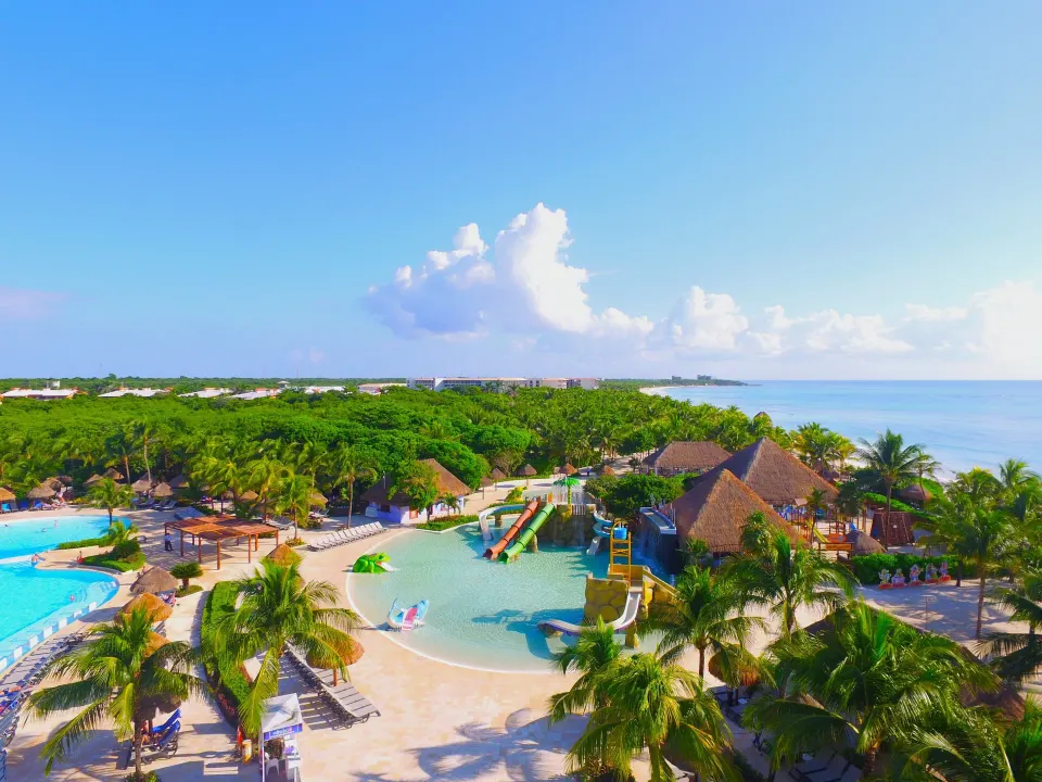 Resort pool and waterpark area with slides and beach at Grand Palladium Colonial Resort & Spa