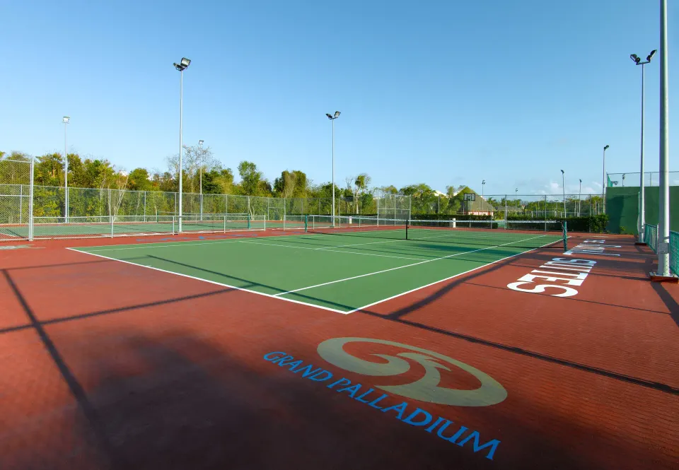 Resort tennis courts with multiple fenced courts at Grand Palladium Colonial Resort & Spa