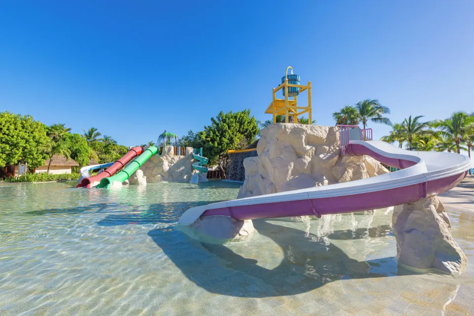 Curving tube slides and shallow splash pool at Grand Palladium Colonial Resort & Spa