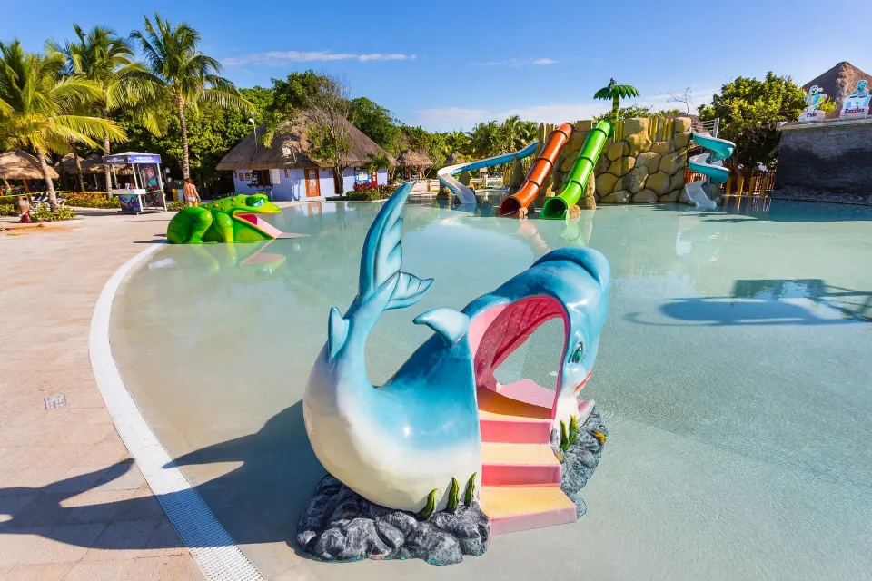 Playful whale-themed slide entry in the kids' pool at Grand Palladium Colonial Resort & Spa