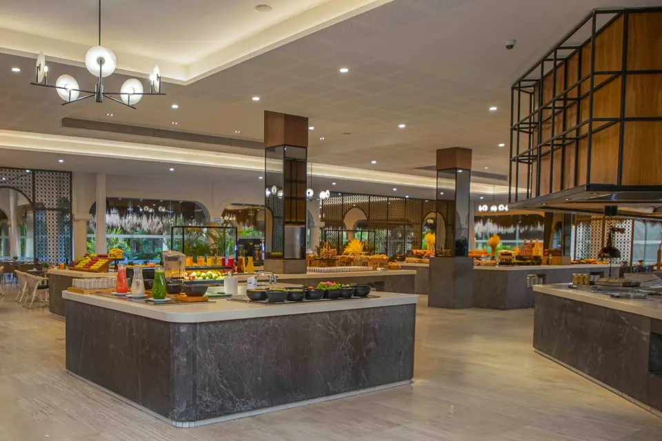Bright buffet dining room with islands and seating at Grand Palladium Colonial Resort & Spa