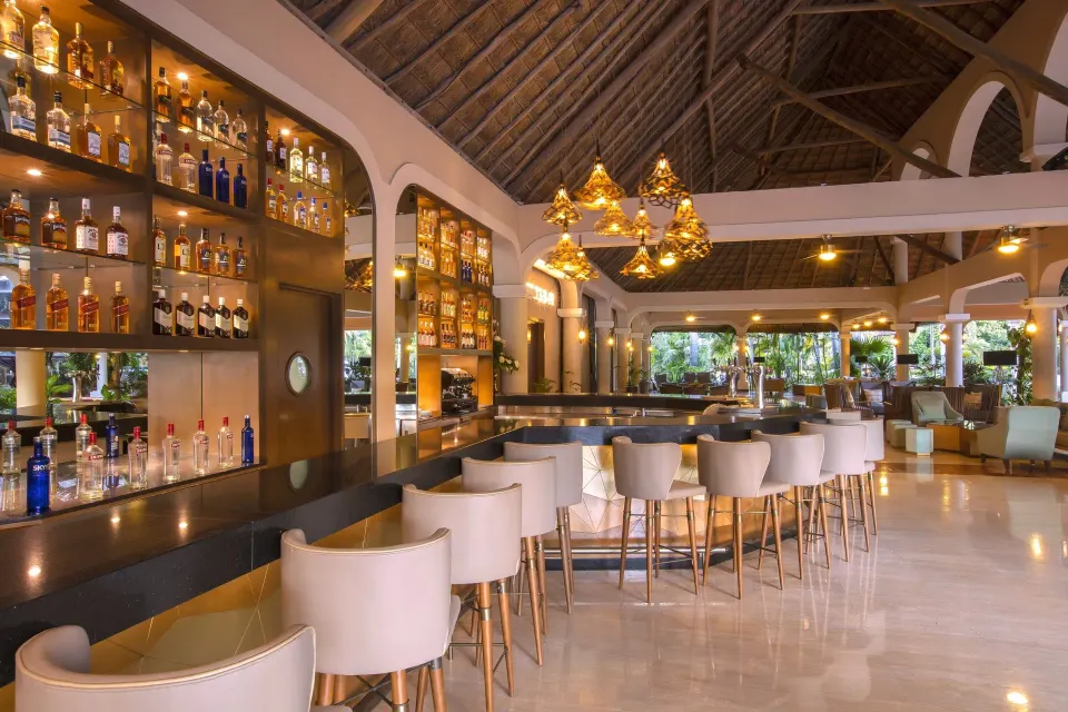 Well-stocked lobby bar with barstools at Grand Palladium Colonial Resort & Spa