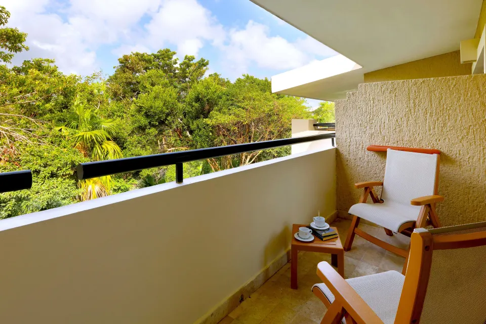 Room balcony with chairs and tree view at Grand Palladium Colonial Resort & Spa